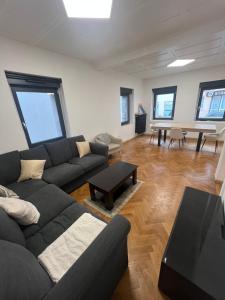 a living room with a couch and a table at Maison 3 chambres in Strasbourg