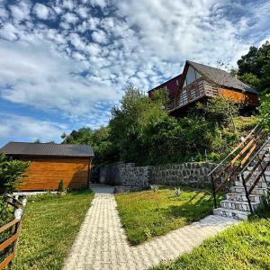 a house sitting on top of a hill with a walkway at SUNSET BUKNARI in Buknari