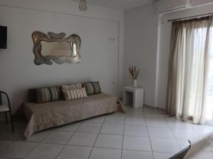 a bedroom with a bed and a mirror on the wall at Niko's apartments 2 in Elafonisos