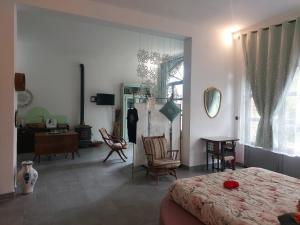 a bedroom with a bed and chairs and a desk at L'Aquila e L'Ulivo in Montepulciano