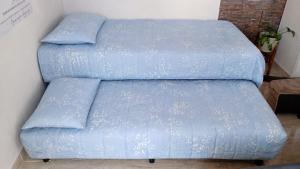 a blue bed with two pillows on top of it at departamento familiar 2 in Malargüe +5 photos