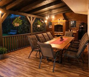 a dining room with a wooden table and chairs at Vila Luna Valea Avrigului in Avrig