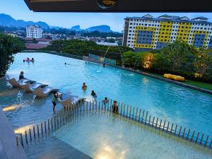 a water park with people in a swimming pool at Piccadilly Residence by LMS ipoh in Ipoh