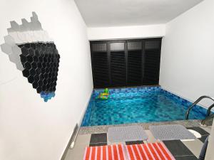 a swimming pool in a room with a wall at DH Villa in Batu Caves
