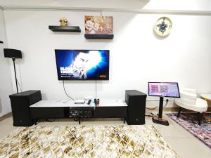 a living room with a tv and a desk at DH Villa in Batu Caves
