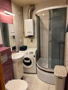 a bathroom with a shower and a toilet and a sink at Piter Piotr Bezpalko in Knurów