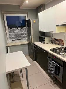 a kitchen with a table and a stove top oven at Piter Piotr Bezpalko in Knurów
