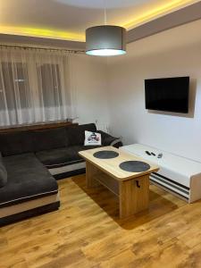 a living room with a couch and a coffee table at Piter Piotr Bezpalko in Knurów