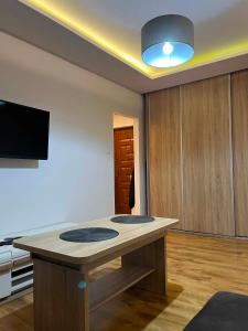 a kitchen with a island in the middle of a room at Piter Piotr Bezpalko in Knurów