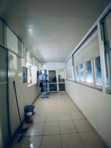 a hallway of a hospital with a room with windows at Meknes Hamria centre ville only families and forneigners in Meknès