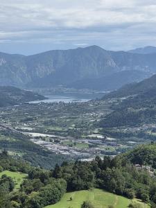 a view of a valley with a lake and mountains at Leonard Chalet House in Albiano