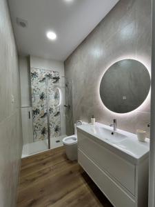 a bathroom with a sink and a toilet and a mirror at Tentietxea in Areatza +7 photos