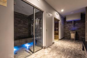 a hallway with a glass shower in a building at Castelmartini Wellness & Business Hotel in Larciano