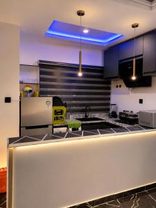 a kitchen with a sink and a refrigerator at PrimeNest Apartment in Lekki
