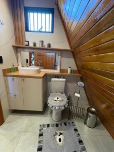 a bathroom with a sink and a toilet in a room at Sítio das Amoreiras- Cabana in Tabapira +18 photos