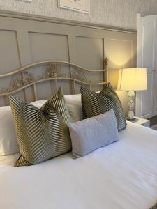 a bedroom with a bed with pillows on it at Antfield House in Inverness