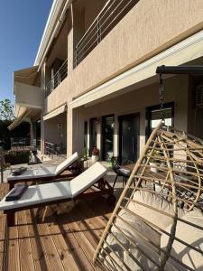 a porch with two beds on a wooden deck at Villa Constangie in Marathon