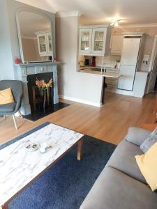 a living room with a couch and a table at Coastal Apartment in Malahide