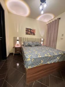 a bedroom with a bed with a blue comforter at Porto Sokhna Pyramids - For Families Only vip in Ain Sokhna +52 photos