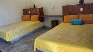 two beds sitting next to each other in a room at Hotel Vista Hermosa Aeropuerto Puerto Vallarta in Puerto Vallarta