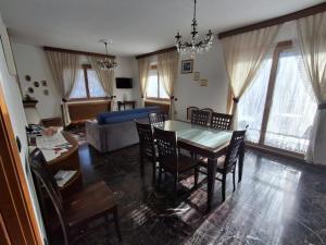 a dining room and living room with a table and chairs at Retica Tirano garage EV Station & Biliards BBQ e private Parking in Tirano