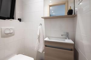 a white bathroom with a sink and a toilet at Sunset Terrace Vinisce in Vinišće