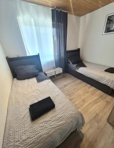 a bedroom with two beds and a large window at Pension Mediterrano - Monteurzimmer in Bedburg +16 photos