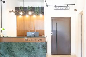 a reception desk with a sign that reads reception at ASO Hotel - Historic Raisin Warehouse 1928 in Kalamata