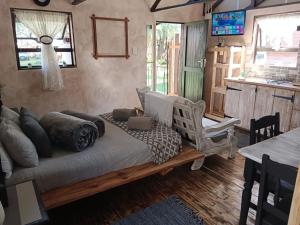 a living room with a couch and a table at Log in At 118 Log 1 in Meyerton