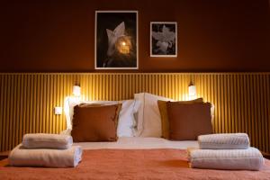 a bedroom with a bed with two pillows on it at Azorica Pico in Madalena