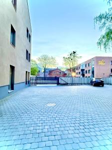 a parking lot with a car parked next to a building at Matas old town apartment in Kaunas +8 photos