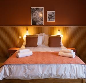 a bedroom with a large bed with two towels on it at Azorica Pico in Madalena
