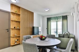 a living room with a table and chairs and a television at Seaside Premium Apartments Bar - Susanj in Bar