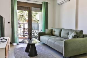 a living room with a couch and a glass table at Seaside Premium Apartments Bar - Susanj in Bar
