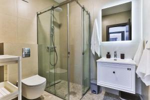 a bathroom with a shower and a toilet and a sink at Seaside Premium Apartments Bar - Susanj in Bar