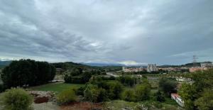 a view of a city with trees and buildings at Hotel KTHELLA in Rrëshen