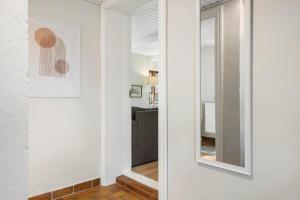 a mirror on a wall next to a room at LF11979-Struer-Havstokken-9-a in Vemb