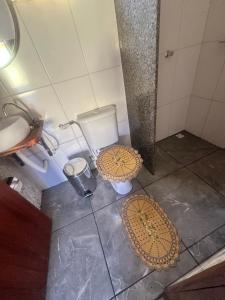 a bathroom with a toilet and a sink at Chalé do coiote! in São Roque de Minas +15 photos