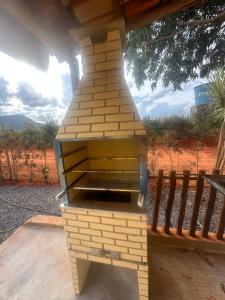 a brick oven sitting on top of a porch at Chalé do coiote! in São Roque de Minas