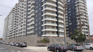 a tall building with cars parked in front of it at Lima Flats 2 in Lima