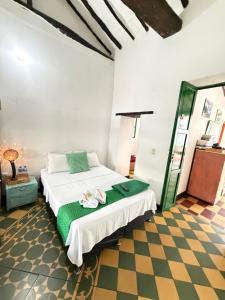 a bedroom with a bed and a checkered floor at Green Door San Gil in San Gil +53 photos