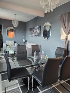 a dining room with a glass table and chairs at Hotel Milenio Nanacamilpa Tlaxcala in Nanacamilpa +27 photos