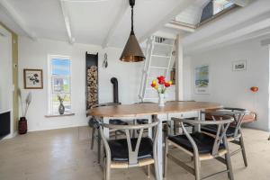 a kitchen with a wooden table and some chairs at 20165-Samso-Marup-Bakkevej-14 in Mårup