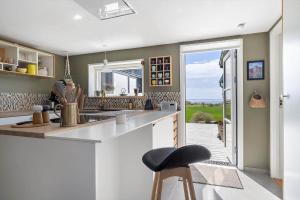 a kitchen with a counter and a stool in it at 20165-Samso-Marup-Bakkevej-14 in Mårup