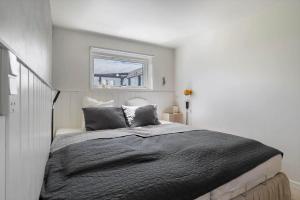 a bedroom with a large bed with a window at 20165-Samso-Marup-Bakkevej-14 in Mårup