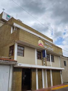 a building with a hotel miller sign on it at Hotel Milenio Nanacamilpa Tlaxcala in Nanacamilpa