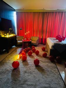 a room with a bed and red balls on the floor at Boutique Hotel in Baghdād