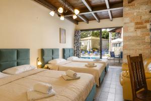 a room with three beds with hats on top of them at Ornella Beach Resort & Villas in Syvota +127 photos