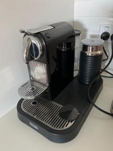 a black coffee maker sitting on a counter at Jacks Point Getaway in Queenstown Airport