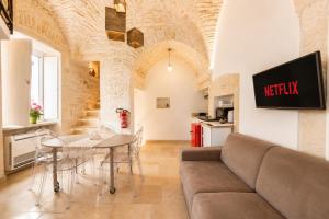 a living room with a couch and a table at Martine Dimore Storiche di Puglia in Martina Franca
